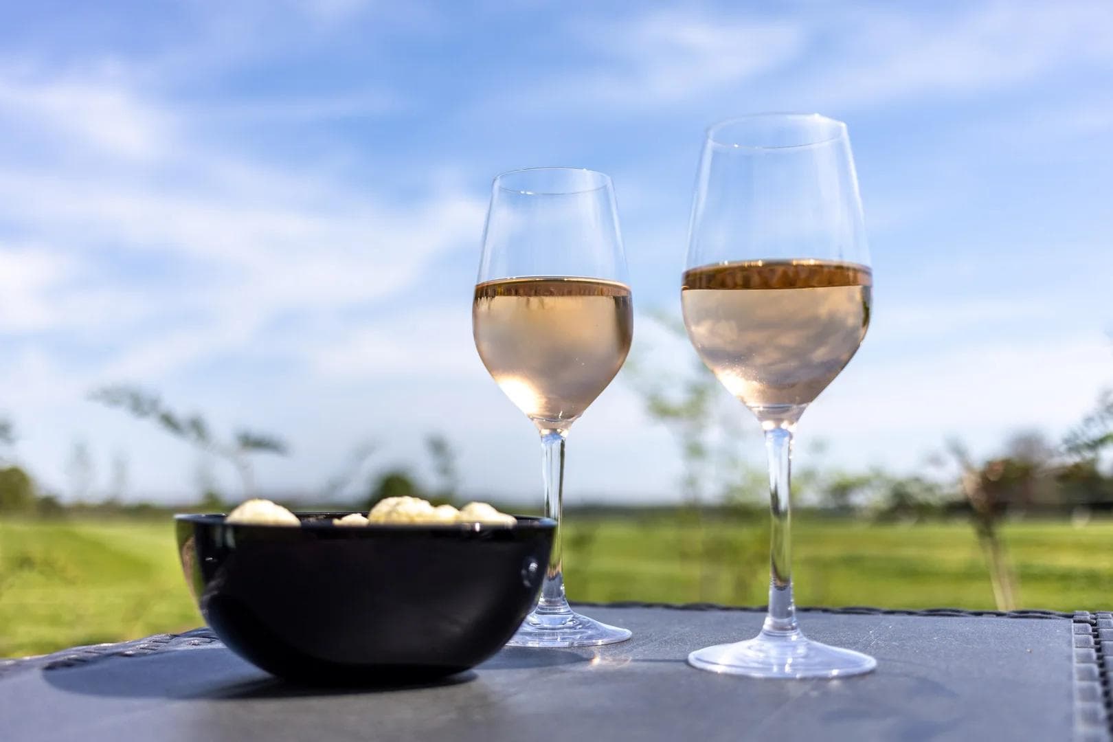 Wine glasses and snacks on the Knowle Grange patio